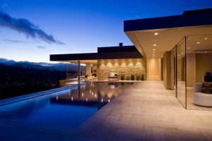 Elegant-swimming-pool-design-with-ceramic-tile-pool-side-also-bright-terrace-decorated-by-recessed-canopy-lamps-and-stone-wall-with-lovely-seat