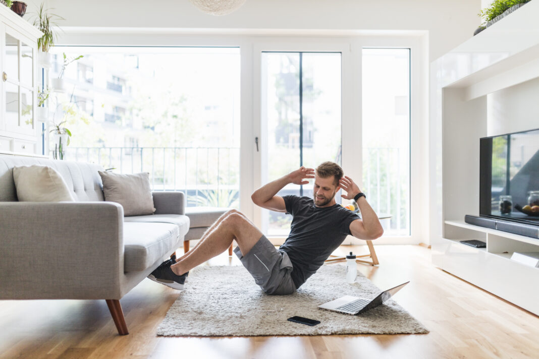 Handsome man working out at home