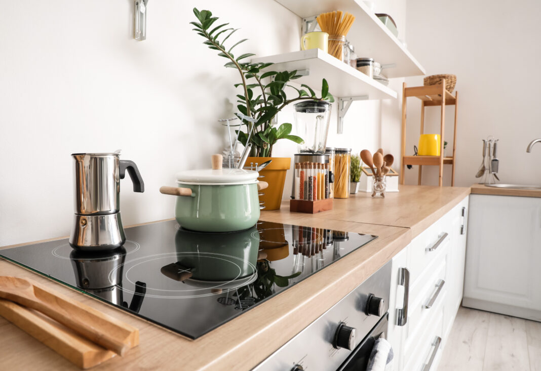 Cooking pot and coffee maker on electric stove in kitchen