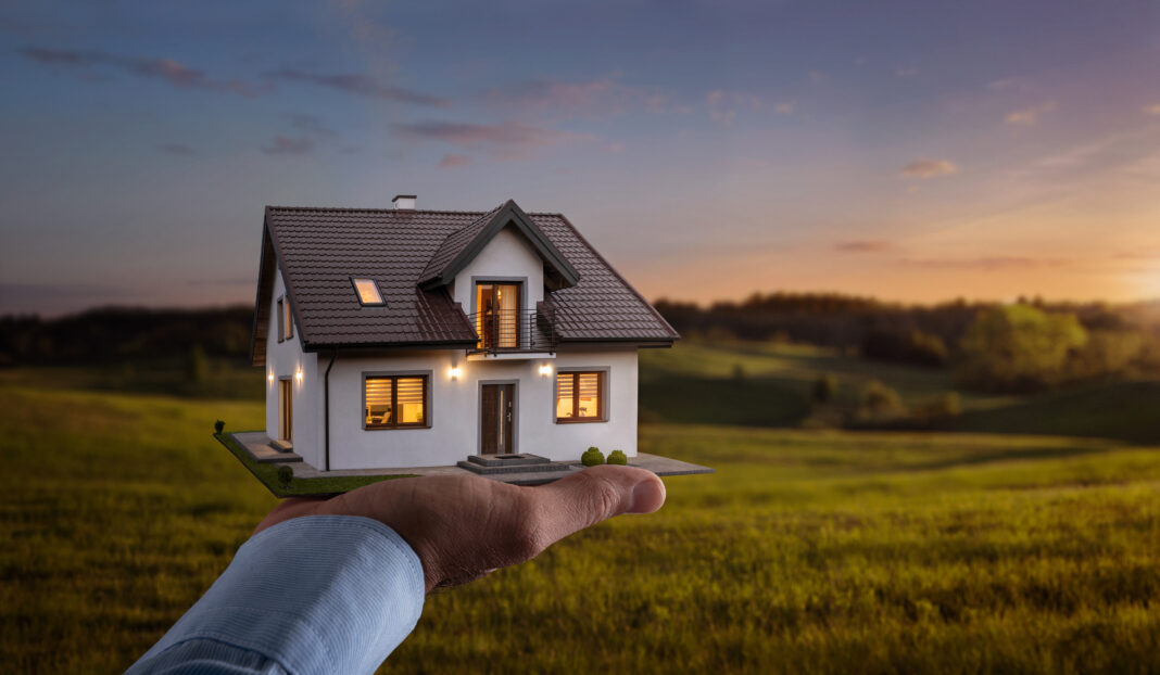 Concept of buying or building new home. Male hand showing, offer