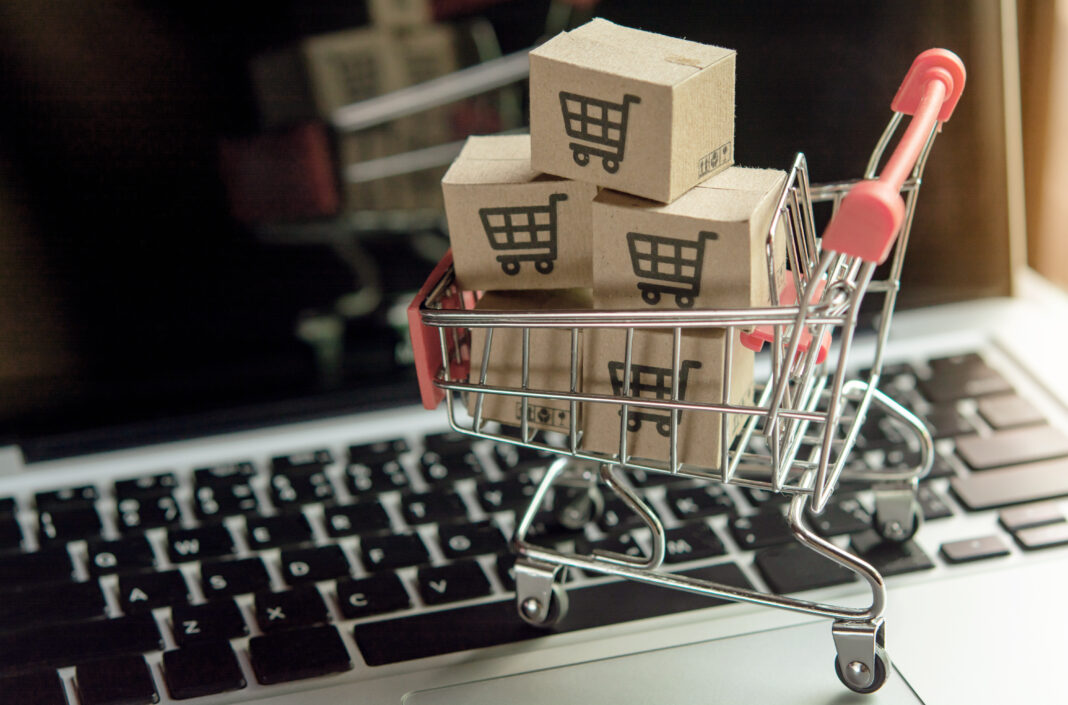 Shopping online concept - Parcel or Paper cartons with a shoppin