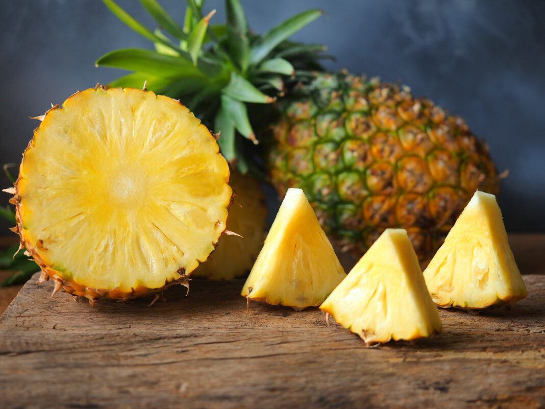 Ripe pineapple fruit cut in half and triangle shape.